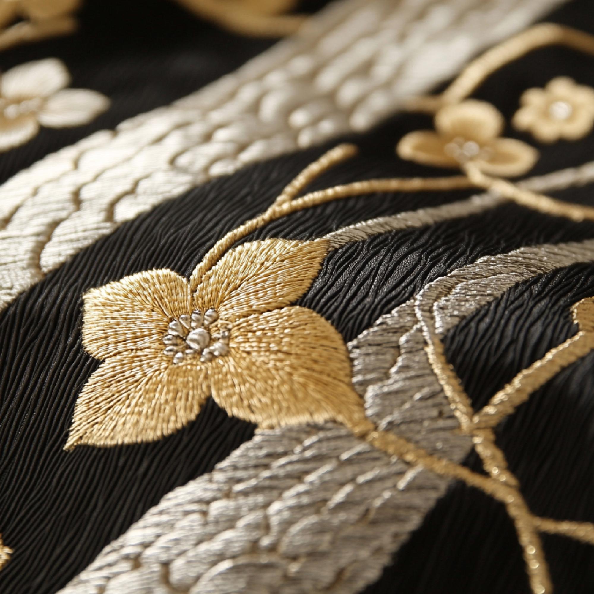 Close-up of gold-thread floral embroidery on silk